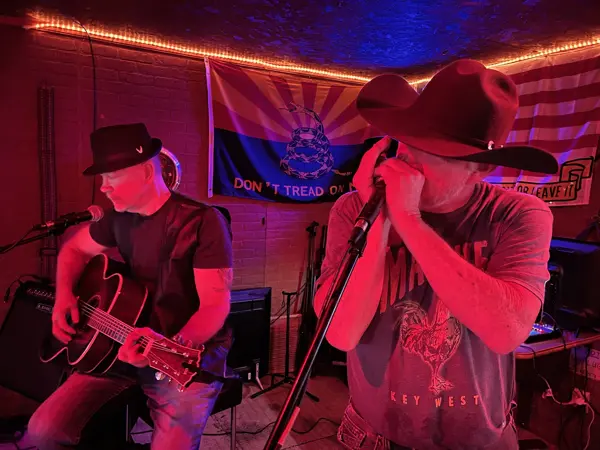 Live band with guitar and harmonica