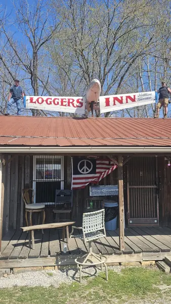 New LOGGERS INN banner going up on the roof