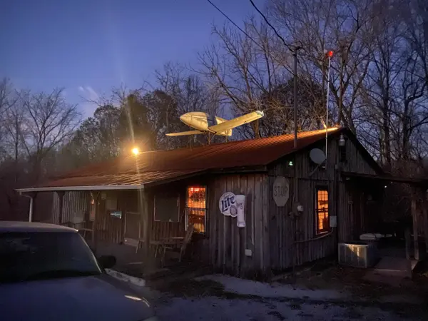 Loggers Inn at dusk with the airplane on the tin roof