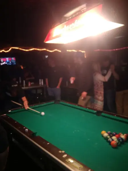 Pool under the Bud Light lamp on a busy night